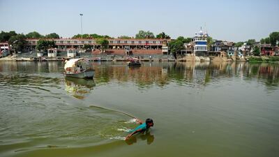 An Indian youth swims in the polluted waters of the river Ganges at Sarsaiya Ghat in Kanpur on June 26, 2014. Sanjay Kanojia/AFP Photo