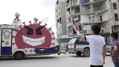 epa08392436 A truck for prevention against the COVID-19 coronavirus disease, operated by local NGO 'Violet Organization', drives through the streets of Idlib, Syria, 29 April 2020. EPA/YAHYA NEMAH