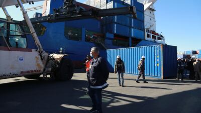 Containers filled with Italian waste illegally imported into Tunisia are loaded onto a ship.