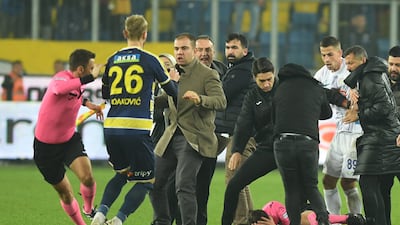 Referee Halil Umut Meler on the ground after being attacked. Reuters
