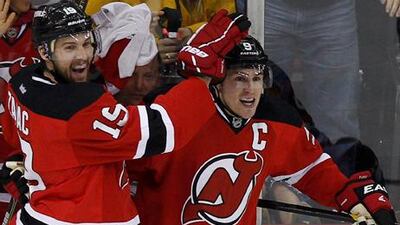 New Jersey Devils' Travis Zajac (left) celebrates with teammate Zach Parise