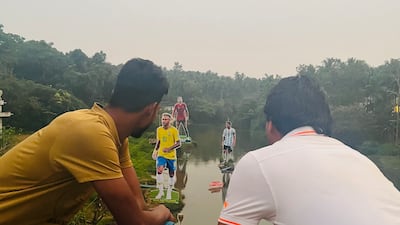 A village in Kerala has become the main attraction for football fans keen to take photographs from a bridge that overlooks the massive cutouts of their football icons. Photo: Pullavoor football fans
