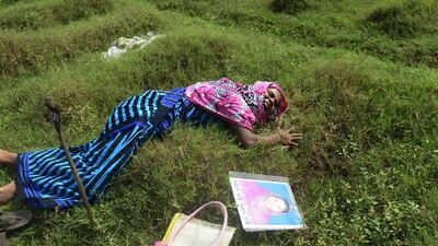 Bangladesh mother, Nazma Begum, grieves at the grave of her garment worker daughter Aakhiat, who was identified through DNA matching as a victim of Bangladesh’s Rana Plaza factory collapse. Munir uz Zaman / AFP