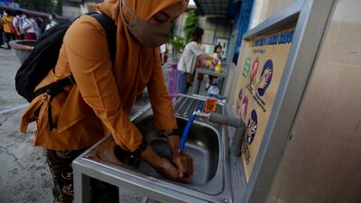 A teacher washes her hands at a school in Banda Aceh, Aceh, Indonesia. EPA