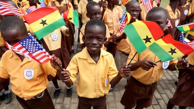 Children carry flags as they greet Melania Trump in Accra, Ghana. Reuters