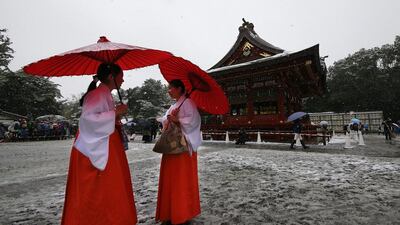 Shrine maidens chat in the snow at the Tsurugaoka Hachimangu Shrine in Kamakura, near Tokyo. Shizuo Kambayashi / AP Photo