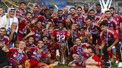 Sharjah celebrate with the League Cup trophy after beating Al Ain in the final at Al Nahyan Stadium. Getty
