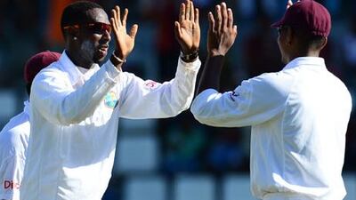 Shane Shillingford, left, celebrates the wicket of Michael Hussey, one of four he took against Australia on the opening day of the third Test.