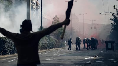 A protester raises his hands in front of riot police. EPA