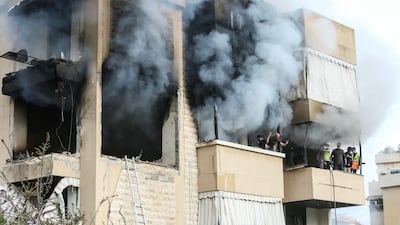 Emergency workers at the site of an Israeli air strike on an apartment building in Haret Saida, on the outskirts of Sidon. AFP