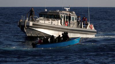 Migrants on a wooden boat are rescued by a patrol vessel of the Tunisia Navy, seen from the migrant search and rescue vessel MV Seefuchs of the German NGO Sea-Eye in the search and rescue zone south of the Al Jurf Oilfield in international waters off the coast of Libya Reuters