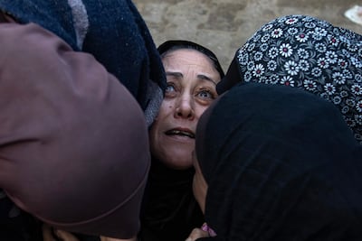 Palestinians mourn next to the bodies of relatives killed in an Israeli air strike west of Khan Younis in the southern Gaza Strip. EPA