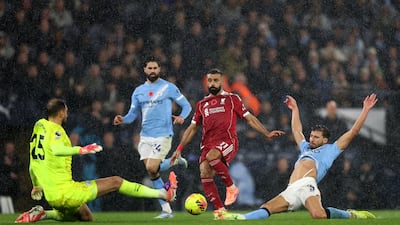 Liverpool attacker Mohamed Salah is challenged by Ruben Dias and Gianluigi Donnarumma of Manchester City. Getty Images