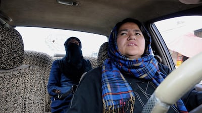 Afghanistan's only known female taxi driver, Sara Bahai, right, drives a customer, in Mazar-i Sharif city, capital of northern Balkh province, Afghanistan. For the sake of her family whom she supports, Ms Bahai risks her life to be a taxi driver. Mustafa Najafizada/AP Photo