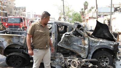 A member of Iraq’s security forces looks at the site of a car bomb attack in Baghdad’s Karrada district on May 9, 2015. Reuters