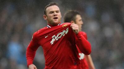 Wayne Rooney of Manchester United celebrates scoring the opening goal during the match against Manchester City.