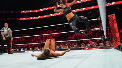 Bayley drops an elbow during a match.