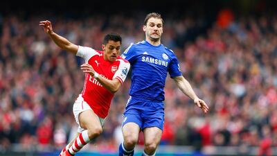 Branislav Ivanovic of Chelsea holds off Arsenal's Alexis Sanchez during their Premier League derby game at Emirates Stadium in London. Julian Finney / Getty Images