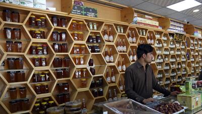 An Afghan shopkeeper sells dates and honey in Kabul, Afghanistan. Shoppers in the Afghan capital are going online for everything from fashion to furniture to avoid bomb attacks. Rahmat Gul / AP Photo