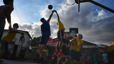 People playing basketball on a street in the Tondo district of Manila, Philippines. AFP