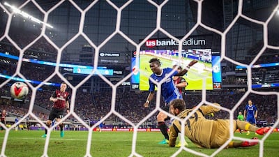 Chelsea forward Bertrand Traore, centre, scores with a header past AC Milan goalkeeper Gianluigi Donnarumma. Aaron Lavinsky / AP Photo