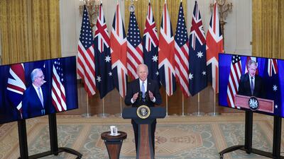 Former US President Joe Biden delivers remarks about the Aukus pact in the White House, in Washington, on September 15, 2021. The then Australian Prime Minister Scott Morrison, left, and British Prime Minister Boris Johnson participated virtually. EPA