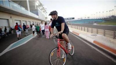 Rory Fidler bikes around the Yas F1 race track as part of his training for Tri Yas in Abu Dhabi. Sammy Dallal / The National