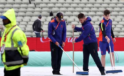 Stadium workers clear water from the covers during last month's New Zealand-Pakistan World Cup match at Edgbaston. Could we see a repeat? Rui Vieira / AP Photo