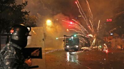 Supporters of Lebanon's Shiite Hezbollah and Amal groups hurl fireworks at security forces in central Beirut. AFP