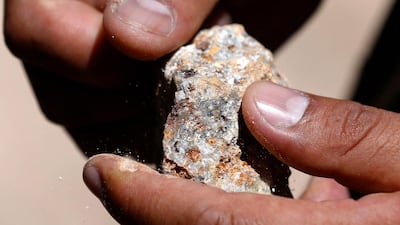 An officer shows a stone with minerals during an operation to destroy illegal gold mining camps in Salpo. Poisonous mercury is used to extract the metal. Mariana Bazo / Reuters