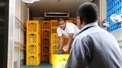Workers unload a food collection truck at the UAE Food Bank in Al Quoz, Dubai, Officials stressed all food donations must be made via such charities and cannot be independently run by members of the public. Pawan Singh / The National