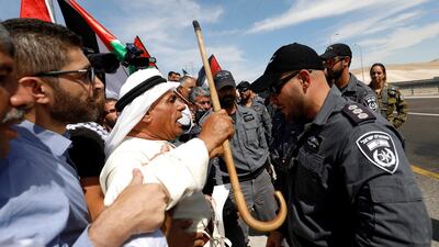 Demonstrators shout slogans in front of Israeli border police officers as they protest against Israel's plan to demolish the Palestinian Bedouin village of Khan al-Ahmar, in the occupied West Bank. Reuters