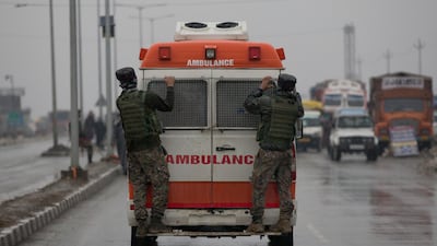 Indian paramilitary soldiers hang on to an ambulance carrying bodies of their colleagues near the site of an explosion in Pampore, Indian-controlled Kashmir. Security officials say at least 10 soldiers have been killed and 20 others wounded by a large explosion that struck a paramilitary convoy on a key highway on the outskirts of the disputed region's main city of Srinagar. AP Photo