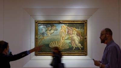 Journalists practice social distancing as they admire the 15th-century painting 'The Birth of Venus' by Italian Renaissance artist Sandro Botticelli. AP Photo