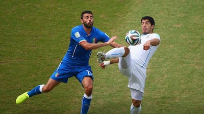 Andrea Barzagli of Italy and Luis Suarez of Uruguay compete for the ball during their match on Tuesday at the 2014 World Cup in Natal, Brazil. Julian Finney / Getty Images