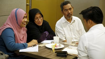Siti, 29, with her parents Zabidah and Jamali, attends Halal Speed Dating, in Kuala Lumpur,. (Olivia Harris / Reuters)