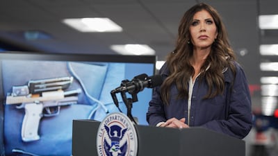 A photograph of the pistol recovered by immigration agents after the shooting in Minneapolis, shown on a screen behind US Secretary of Homeland Security Kristi Noem, at the Federal Emergency Management Agency headquarters. AFP