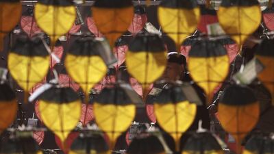 A man walks by a display of paper lanterns hanging at the Jogye Temple in Seoul, South Korea. Lee Jin-man / AP Photo