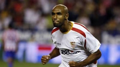 The Sevilla striker Frederic Kanoute wheels away in celebration after scoring the winner against Sporting Gijón.