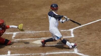 Kelly Kretschman of the USA hits a three-run home run as China's catcher Guo Jia, left, looks on in their women's softball.