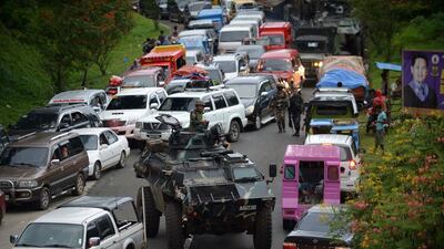 An armoured personnel carrier belonging to the Philippine security forces manoeuvres past gridlocked vehicles of residents fleeing the city of Marawi on May 25, 2017, as fighting between ISIL-linked militants and government troops rages. Ted Aljibe / AFP