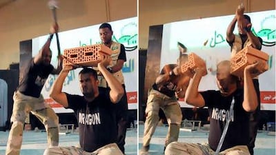 Martial arts performers of the Dragon show team break bricks over a team member's head during a public performance in Riyadh.