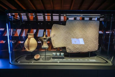 Ceramic coffee cups, water jugs and a sleeping mat made from palm fronds are some of the items pearl divers took with them to sea. Victor Besa / The National