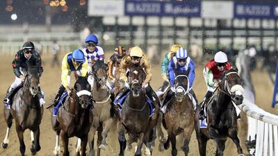 Cosmo Charlie, right, ridden by Pat Dobbs wins the Entisar at a race meeting at Meydan Racecourse in Dubai. All photos by Chris Whiteoak / The National