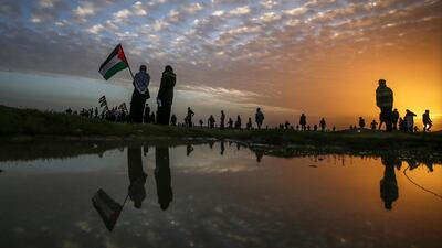Palestinians linger after Friday protests near the border between Israel and Gaza Strip, east Gaza. EPA