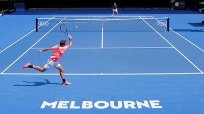 Roger Federer, near, and David Goffin in action on the practice courts at Melbourne Park ahead of the Australian Open. David Gray / Reuters