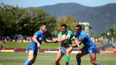 Api Pewhairangi of Ireland, centre, is tackled during the 2017 Rugby League World Cup match against Italy at Barlow Park in Cairns, Australia. Chris Hyde / Getty Images