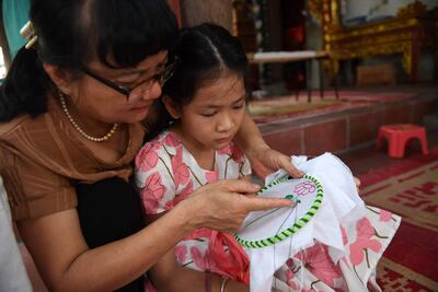 A child learns embroidery during a lesson in Hanoi on July 19, 2022. Photo: AFP