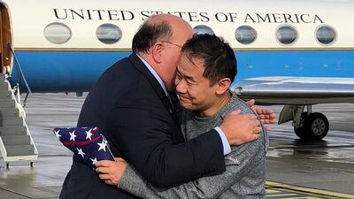 US Ambassador to Switzerland Edward McMullen, Jr, presents a US flag to and welcomes Princeton graduate student Xiyue Wang on arrival in Switzerland after his release from Iran. AFP