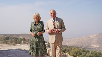 Prince Charles and Camilla, Duchess of Cornwall, wearing a black and khaki Fiona Clare dress, take a walking tour of Umm Qais in Jordan. Getty Images